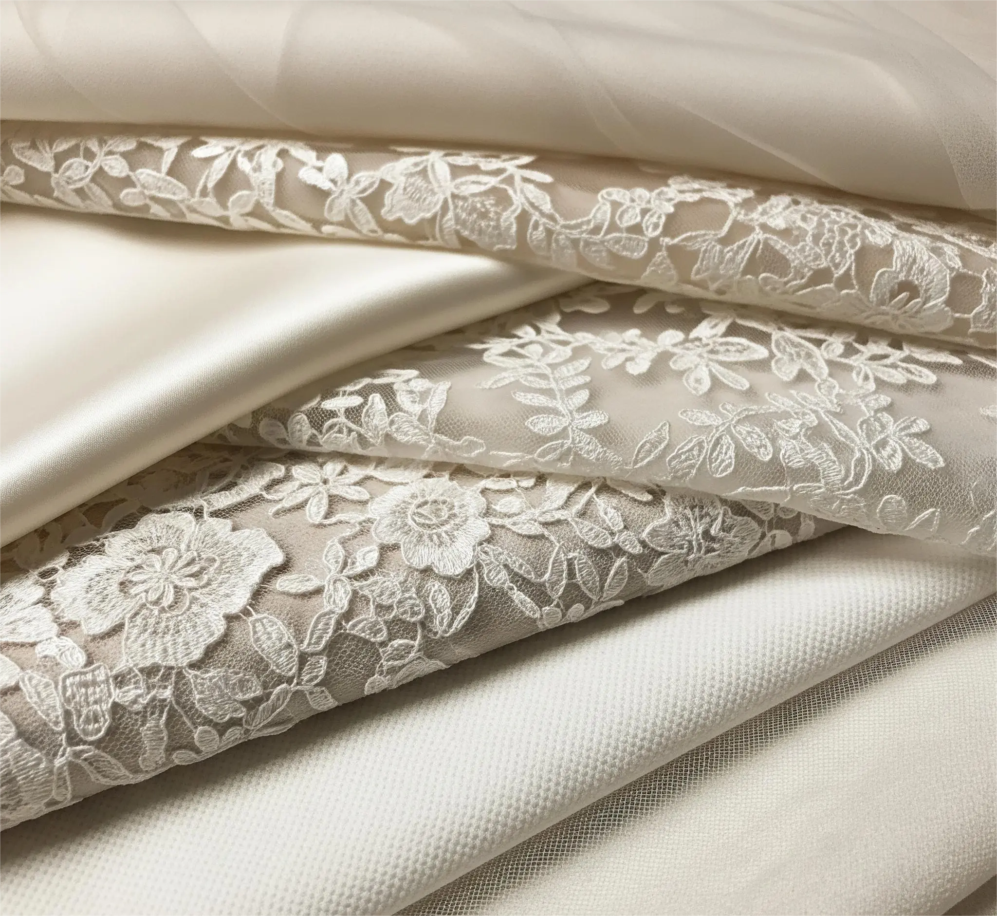 A selection of luxurious textiles featured in this bridal fabrics guide.